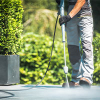 Pressure washer on sidewalk